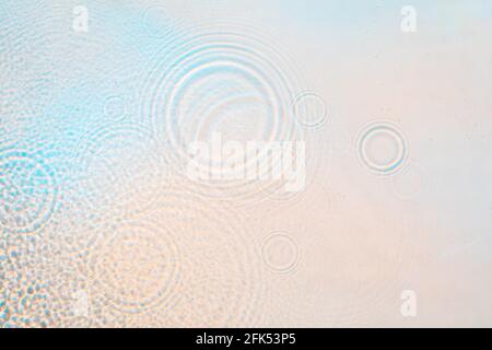 Light wavy with rainbow colors abstract rippled water texture background Stock Photo