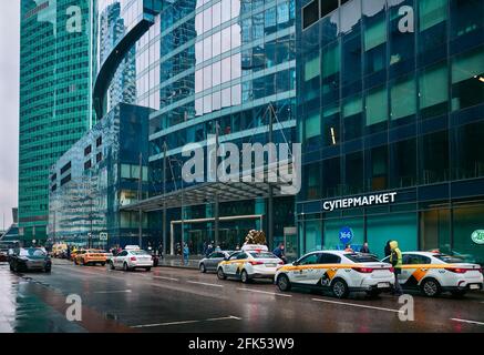 Everyday metropolitan life, cab cars near the Federation Tower in Moscow City Business Center: Moscow, Russia - April 21, 2021 Stock Photo