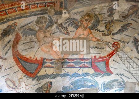 Ancient Roman mosaic of cupids fishing in a boat in a sea full of fish. An allegory for finding love. From the UNESCO listed Ancient Roman mosaics in Stock Photo