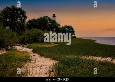 Sun setting over the lighthouse at St Marks National Park in Northern Florida Stock Photo