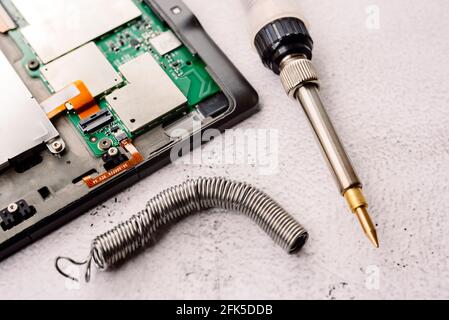 Electronic product warranties do not cover botched repairs made with tin soldering irons. Stock Photo