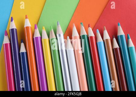 Close up picture of many colored pencil crayons on white