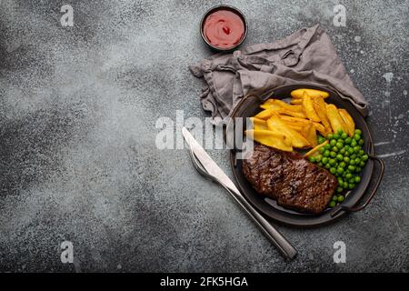 Grilled meat steak with potato chips and salad sirloinfrom above copy space Stock Photo