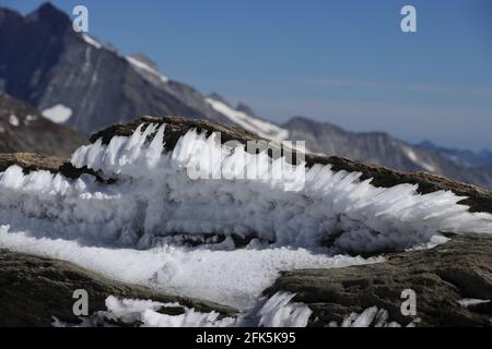 Small rock cave with ice needles. Jungfraujoch, Swiss Alps. Stock Photo