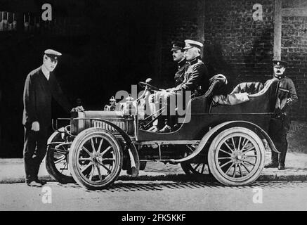 A prototype 10 H.P., 2 cylinder, Rolls Royce car being tested for possible military use in 1904, the year Henry Royce was introduced to Charles Rolls in Manchester. Royce ran an electrical and mechanical business since 1884, while Rolls was one of Britain’s first car dealers, it was the two-cylinder Royce 10 that was made by Royce in 1904 that brought the two men together. Charles Rolls is at the wheel in the vintage photograph. Stock Photo