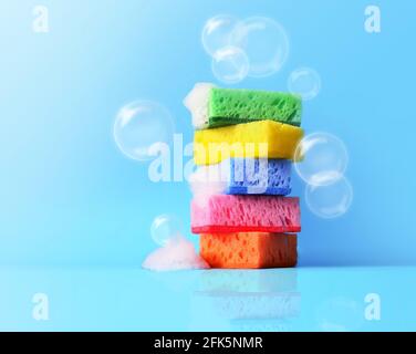 sponges cleaning kit isolated on blue background and foam Stock Photo