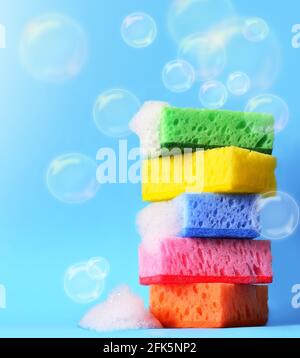 sponges cleaning kit isolated on blue background and foam Stock Photo