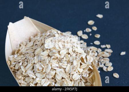 Close up picture of oat flakes in a wooden bowl, selective focus. Stock Photo