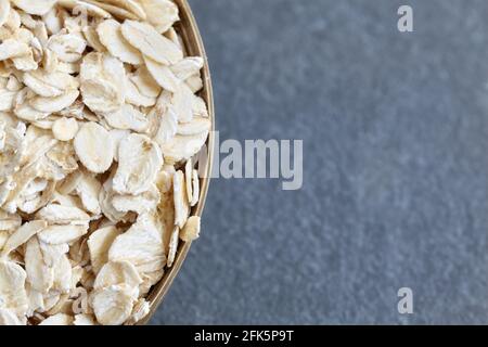 Close up picture of oat flakes in a bowl, selective focus, space for text. Stock Photo