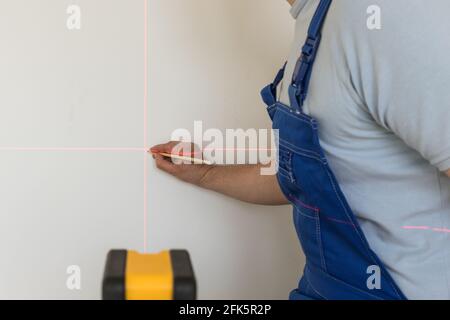 electronic spirit level for marking straight angles. Professional setting a point Stock Photo