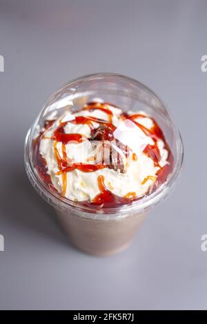 milkshake with caramel in a plastic cup. Stock Photo