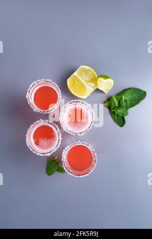 set of four pink cocktails with lime and mint top view. Stock Photo
