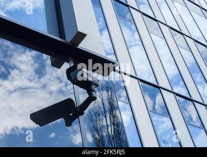 Outdoor CCTV - security camera in a modern office. Black cam Stock Photo
