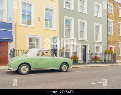July 2020. London. Colourful buildings and Nissan Figaro car in Notting Hill, London, England Stock Photo