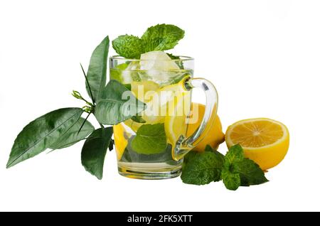 Non-alcoholic refreshing drink with lemon, mint leaves and ice cubes. Isolated on a white background. Selective focus. Stock Photo