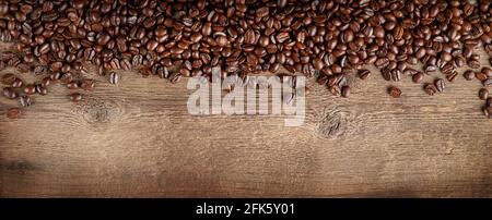 Coffee beans border on dark wooden background. Copy space, overhead. Stock Photo