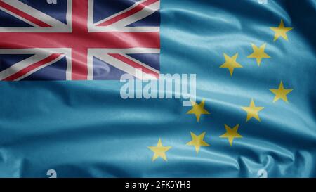 Tuvaluan flag waving in the wind. Close up of Tuvalu banner blowing, soft and smooth silk. Cloth fabric texture ensign background. Stock Photo