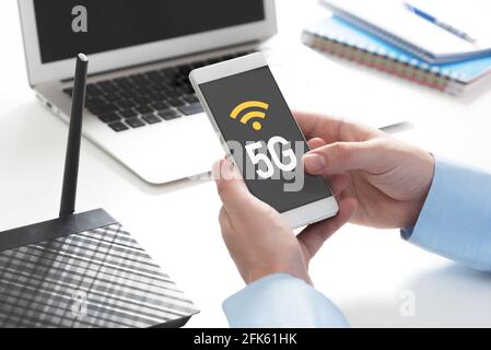 5G technology, high speed communication, data transmission. Hand holding smartphone Stock Photo