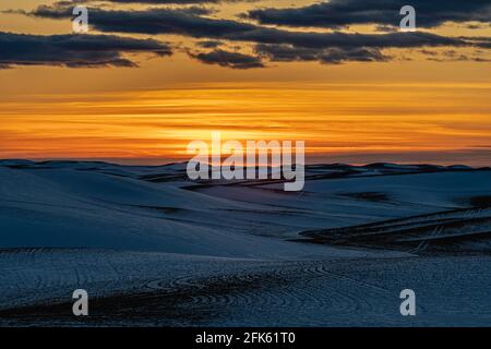 Sunset over Snow Covered Fields Stock Photo