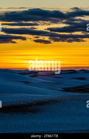 Sunset over Snow Covered Fields Stock Photo
