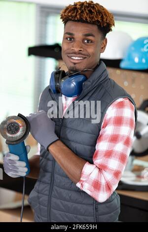 man posing with an angle grinder in his hands Stock Photo