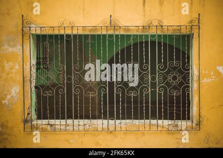 Wrought Iron, yellow facade from a house in Izamal, Yucatan, Mexico. Stock Photo