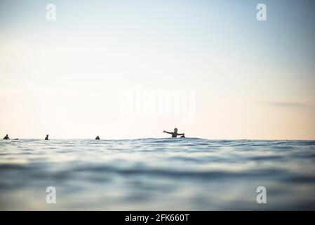 Asian Woman having fun in surf lineup on an early summer morning Stock Photo