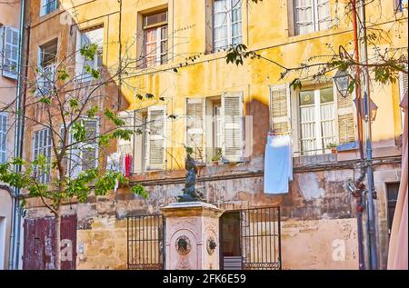 The scenic Fontetes fountain with a little Triton, sitting on the turtle and blowing the horn, located in Fontetes Square, next to the Rue Merindol st Stock Photo