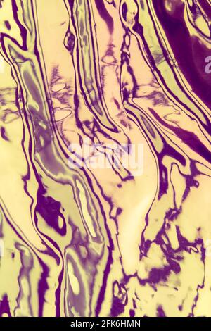 Iridescent background. Holographic wrinkled abstract foil texture. Glittering blurred surface pack. Vertical photo. Stock Photo