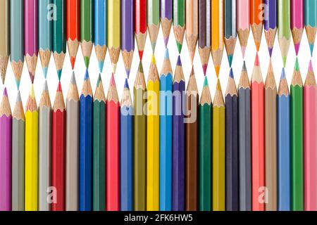 Variety of colored pencils arranged as a wave form. School art supplies isolated on white background Stock Photo