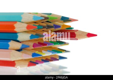 Soft focus close up tip of colorful colored pencils with sharp red one standing out, on white background Stock Photo