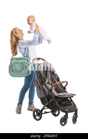 Woman with her cute baby and stroller on white background Stock Photo