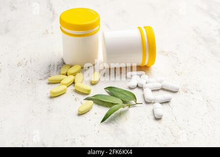Bottles with different pills on light background Stock Photo