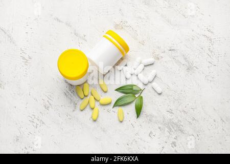 Bottles with different pills on light background Stock Photo