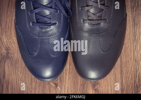 Elegant stylish comfortable navy blue and brown shoes for men on board Stock Photo