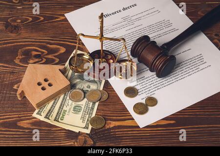 Scales of justice, money and judge's gavel on wooden background Stock Photo