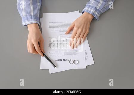 Woman with divorce decree and rings, closeup Stock Photo - Alamy