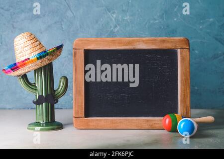 Chalkboard, maracas and sombrero hat on light background Stock Photo