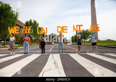 Washington, DC, USA. 28th Apr 2021.   Pictured: Immigrants and supporters march to demand an end to deportations, which Biden has promised to end - but has not - for the duration of his first 100 days in office.  Credit: Allison C Bailey / Alamy Live News Stock Photo