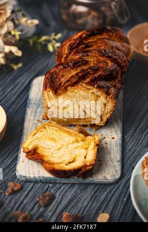 Homemade salted caramel babka on wooden cutting board Stock Photo