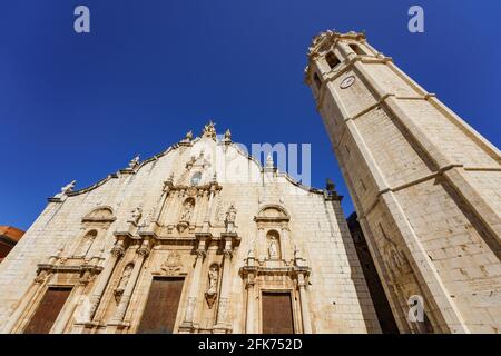 Alcala de Xivert, Spain .Baroque style facade of 'San Juan Bautista' Church and 68-meter bell tower built in the 17th century. Stock Photo