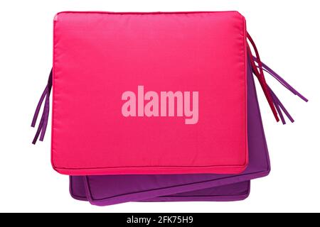 Pile of colorful outdoor cushion, waterproof pillow pad in pink purple isolated on white background Stock Photo