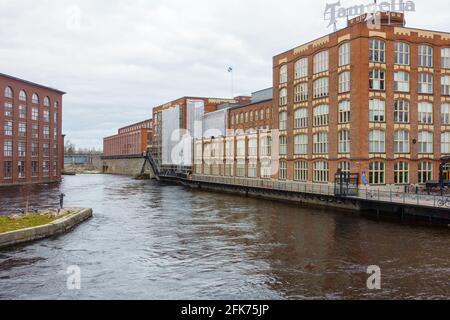 Old Tampella and Finlayson industrial buildings by the water in Tampere Finland Stock Photo