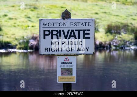 Surrey UK- April 2021: Wotton Estate sign along country hiking path in the Surrey Hills warning of snakes Stock Photo