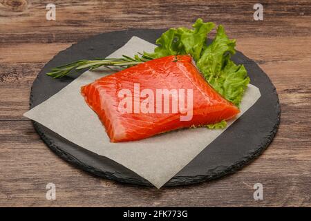 Salted Salmon piece steak served rosemary Stock Photo