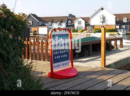 A sign for Wroxham Boat Hire for self drive day boats by the River Bure riverside at Hoveton, Norfolk, England, United Kingdom. Stock Photo