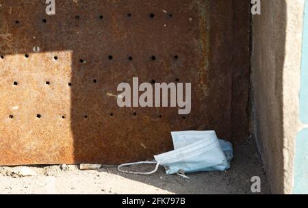 Photo of throwed used protective mask on the ground Stock Photo