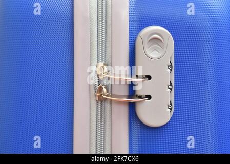 Combination lock close up on blue travel suitcase Stock Photo