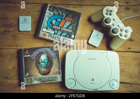 Sony Playstation One Slim with memory cards and controller on wooden table background Stock Photo