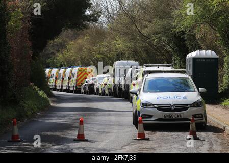 Police vehicles near to the scene in Snowdown, Kent, where the body of PCSO Julia James was found. Kent Police have launched a murder enquiry following the discovery of the 53-year-old community support officer on Tuesday. Picture date: Thursday April 29, 2021. Stock Photo